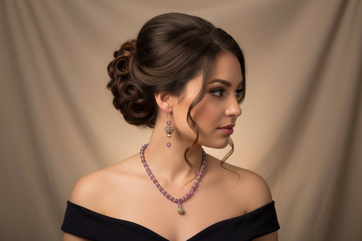 Purple beaded necklace and earrings on a white card with a floral-patterned dish in the background.